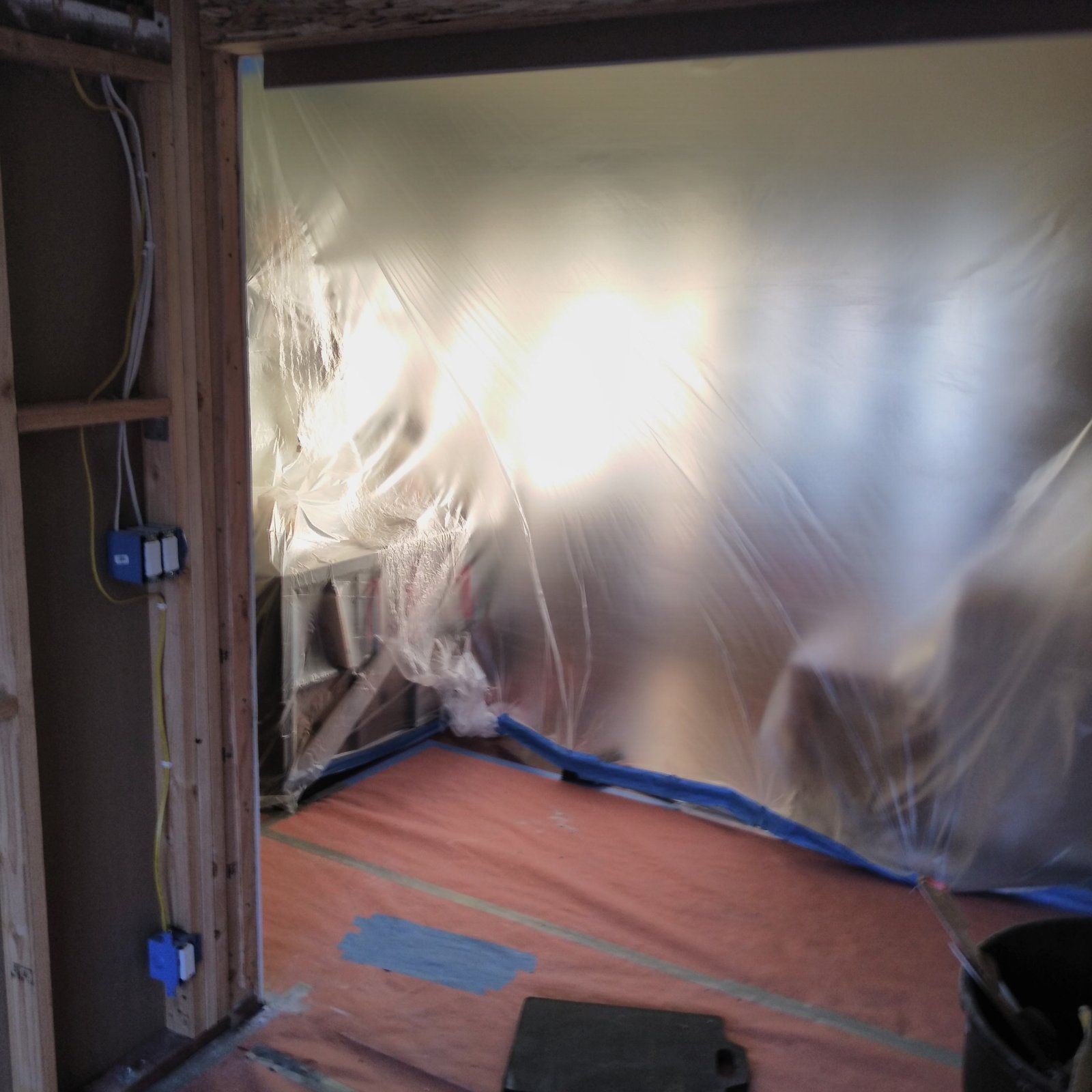 Plastic sheeting hung and floors covered before demolition